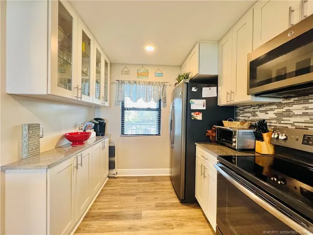 a view of kitchen and wooden floor