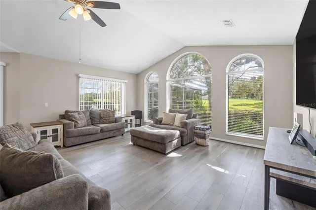 a living room with furniture and a large window