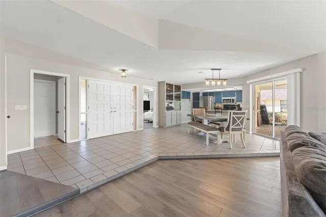 a view of a livingroom with furniture and floor to ceiling window