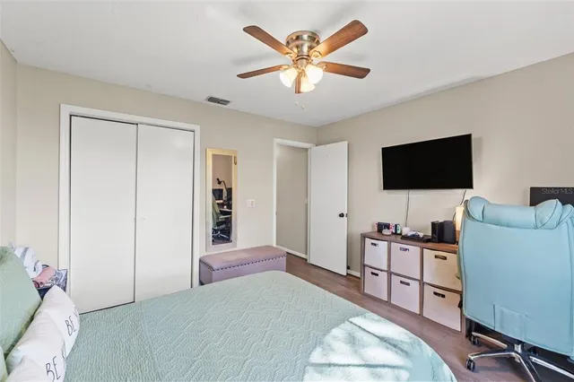 a bedroom with a bed and a flat screen tv