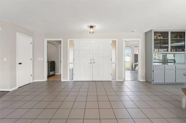 an empty room with closet and windows