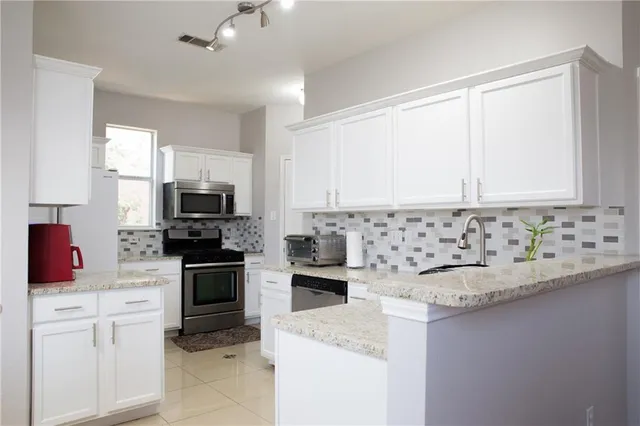 a kitchen with a sink stove and microwave