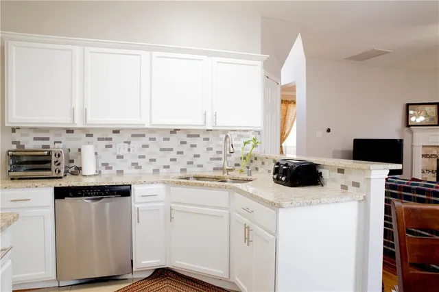 a kitchen with a sink and white cabinets