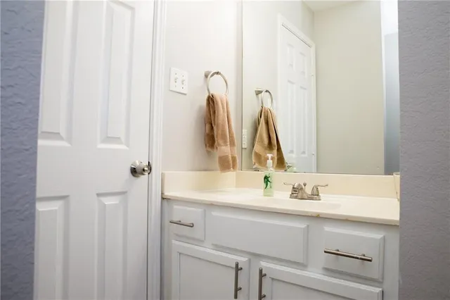 a bathroom with a sink vanity and a mirror