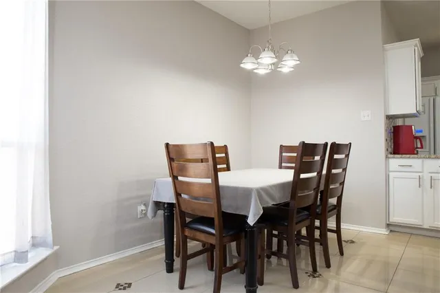 a view of a dining room with furniture and chandelier
