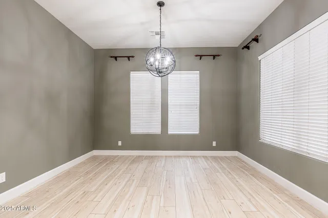 a view of a room with windows and chandelier