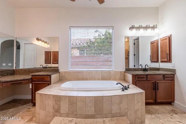 a spacious bathroom with a granite countertop sink and a large mirror