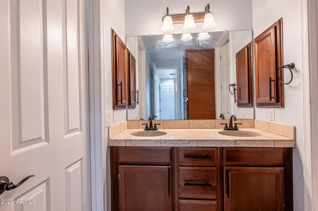 a bathroom with a double vanity sink and a mirror