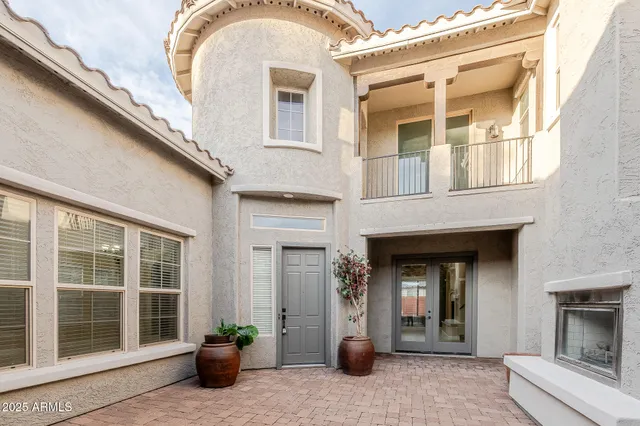 a view of the house with potted plants