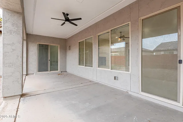 a view of an empty room with a ceiling fan