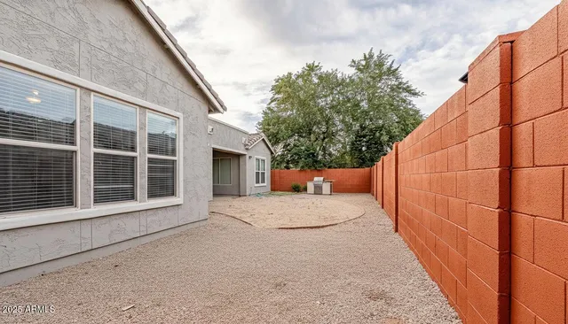 a view of a house with a wooden fence