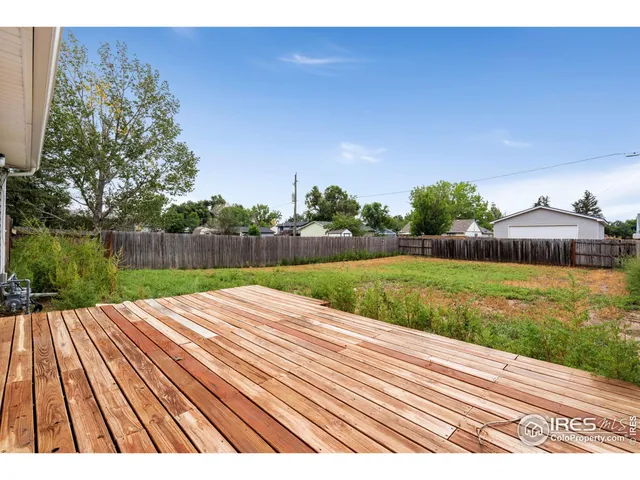 a view of backyard with wooden fence