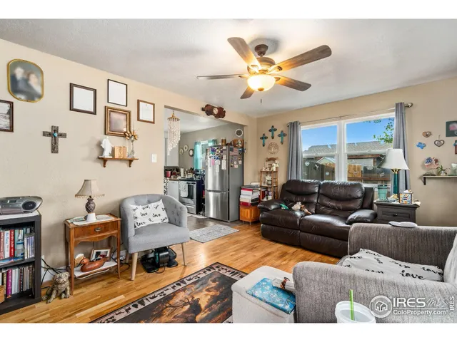 a living room with furniture a rug and a chandelier