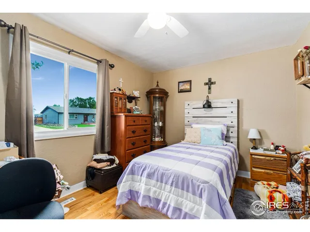 a bedroom with a bed and a chair