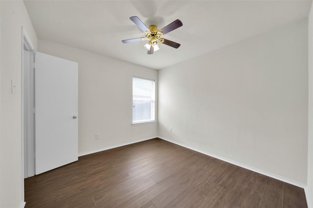 4221 Fiste Denton, TX 76207 - Photo 21 of 26 Unfurnished room with ceiling fan and dark hardwood / wood-style flooring