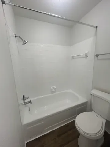 a bathroom with a toilet and a bath tub