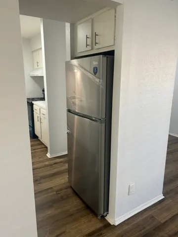 a view of storage and utility room with wooden floor