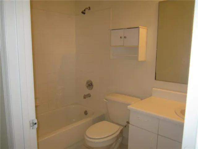 a bathroom with a toilet and shower