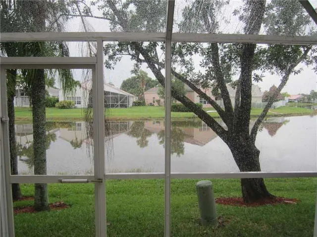 a view of a small yard and a large tree