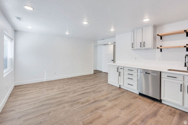 252 North Sunrise Rnch Drive Mapleton, UT 84664 - Photo 42 of 62 Open-concept living area featuring wood-finish flooring, recessed lighting, and a white kitchen with shaker cabinets, stainless steel dishwasher, and open shelving