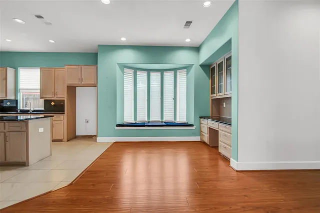 a kitchen with a refrigerator and a stove top oven