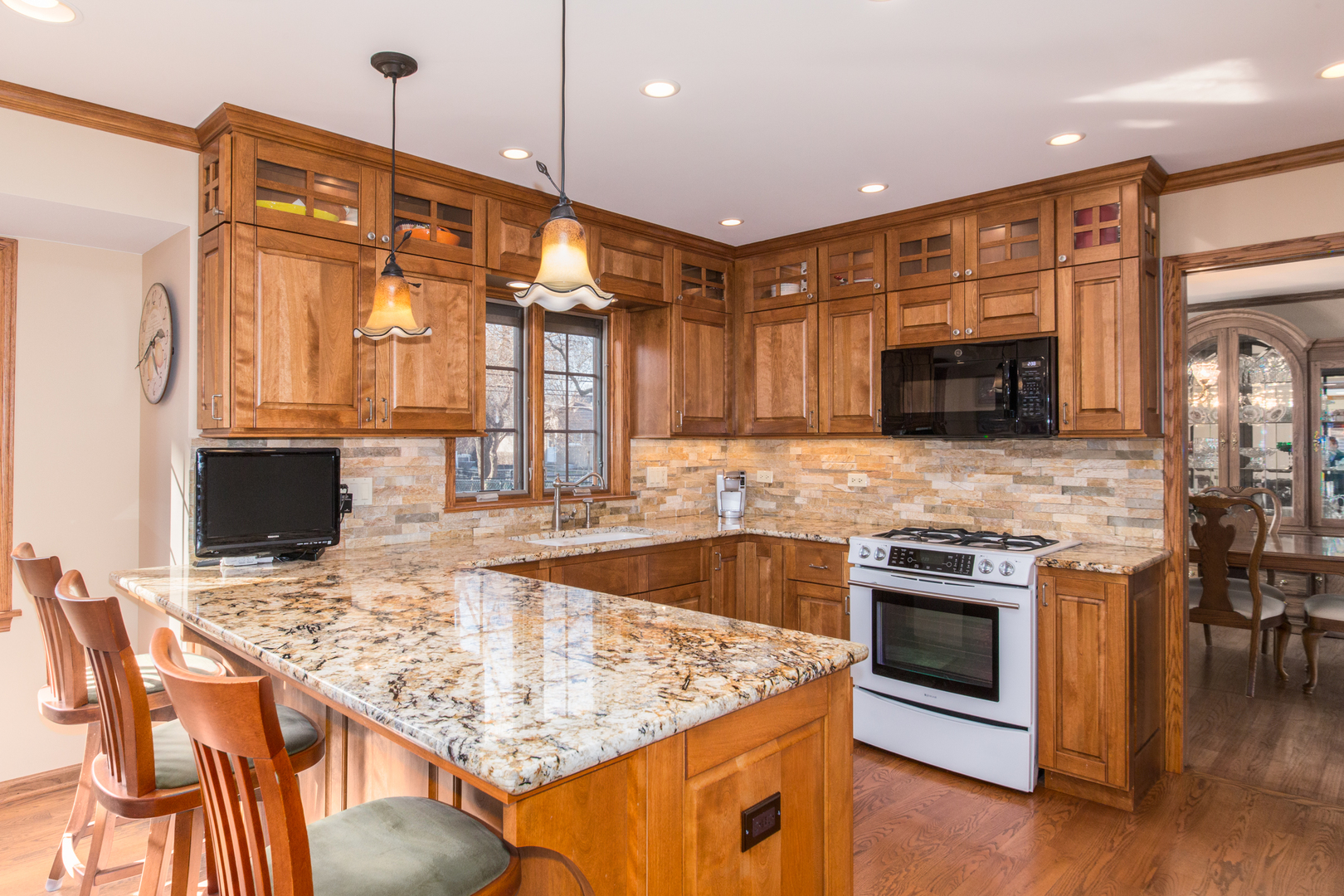 812 South Seminary Avenue Park Ridge, IL 60068 - Photo 9 of 35 a kitchen with stainless steel appliances granite countertop a stove top oven a sink dishwasher a dining table and chairs with wooden floor