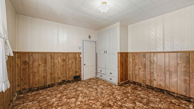 44 Shriver Street Eureka, UT 84628 - Photo 10 of 43 Room featuring wall paneling, a built-in wardrobe with four drawers, and a ceiling-mounted light fixture