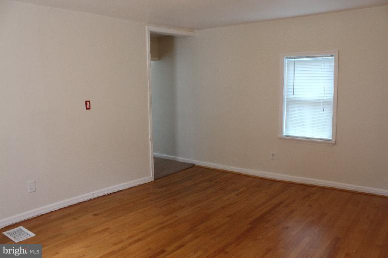 6 Williams Street Glassboro, NJ 08028 - Photo 5 of 11 a view of an empty room with wooden floor and a window