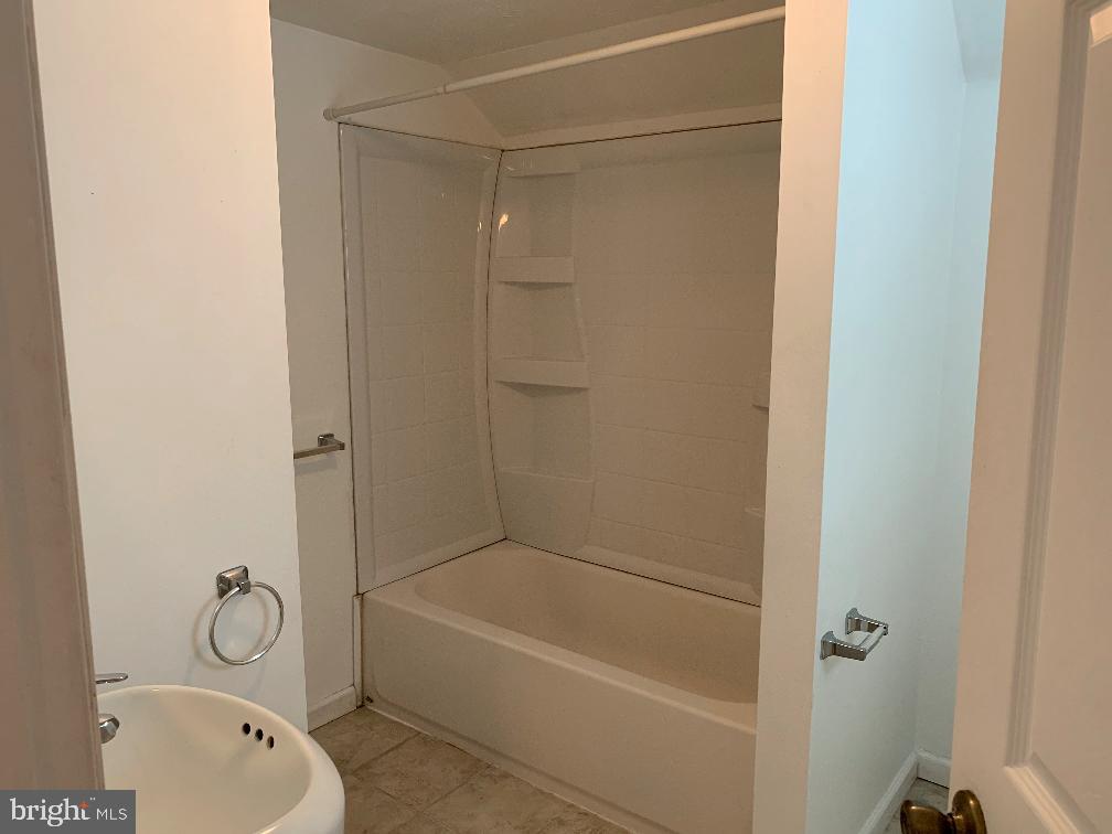 6 Williams Street Glassboro, NJ 08028 - Photo 9 of 11 a bathroom with a granite countertop bathtub shower and a toilet