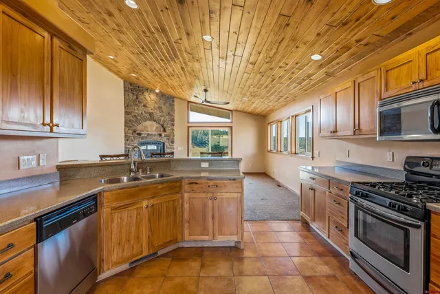 a kitchen with a sink stove and cabinets