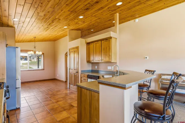 a view of a kitchen with a sink and cabinets