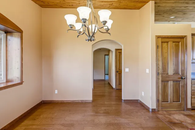 a view of a livingroom with wooden floor and entryway