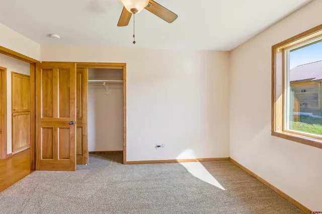 an empty room with windows and closet