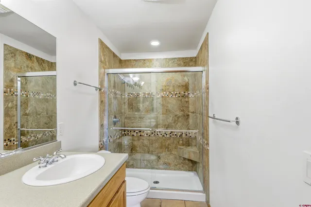 a bathroom with a shower and a sink