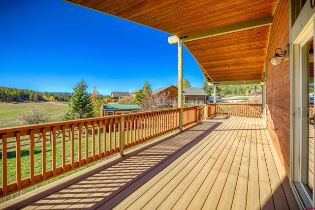 a view of balcony with wooden floor and fence