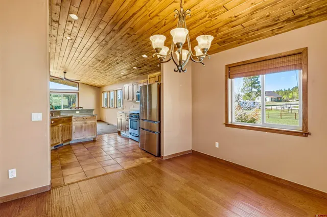 a view of a living room and chandelier with a fireplace