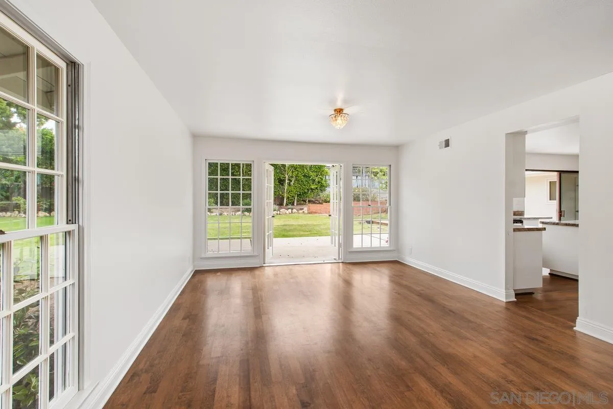 6229 La Jolla Mesa Drive La Jolla, CA 92037 - Photo 11 of 39 a view of an empty room with wooden floor and a window