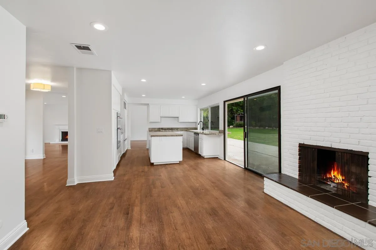 6229 La Jolla Mesa Drive La Jolla, CA 92037 - Photo 14 of 39 a view of a kitchen with a sink a fireplace and a window