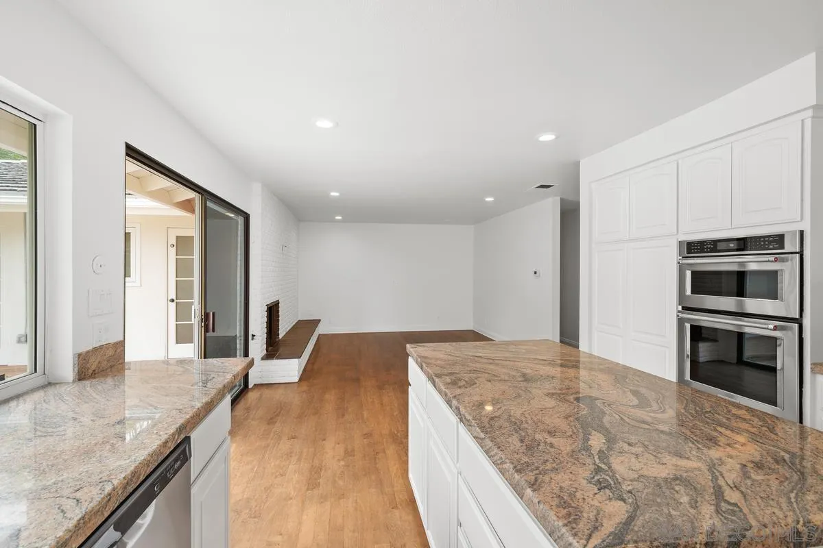 6229 La Jolla Mesa Drive La Jolla, CA 92037 - Photo 17 of 39 a large kitchen with kitchen island granite countertop a large counter top stainless steel appliances and cabinets