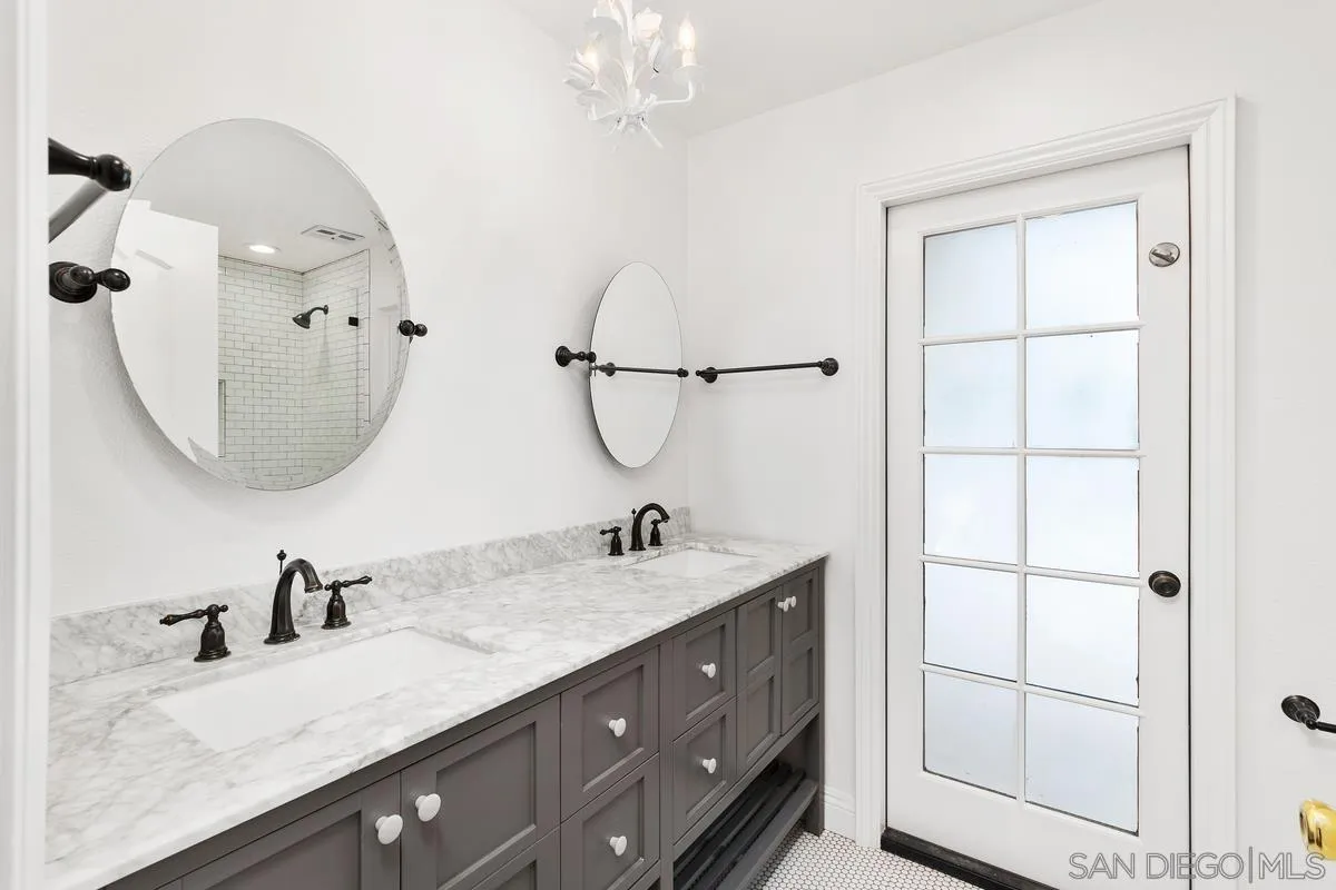 6229 La Jolla Mesa Drive La Jolla, CA 92037 - Photo 23 of 39 a bathroom with a double vanity sink and a mirror
