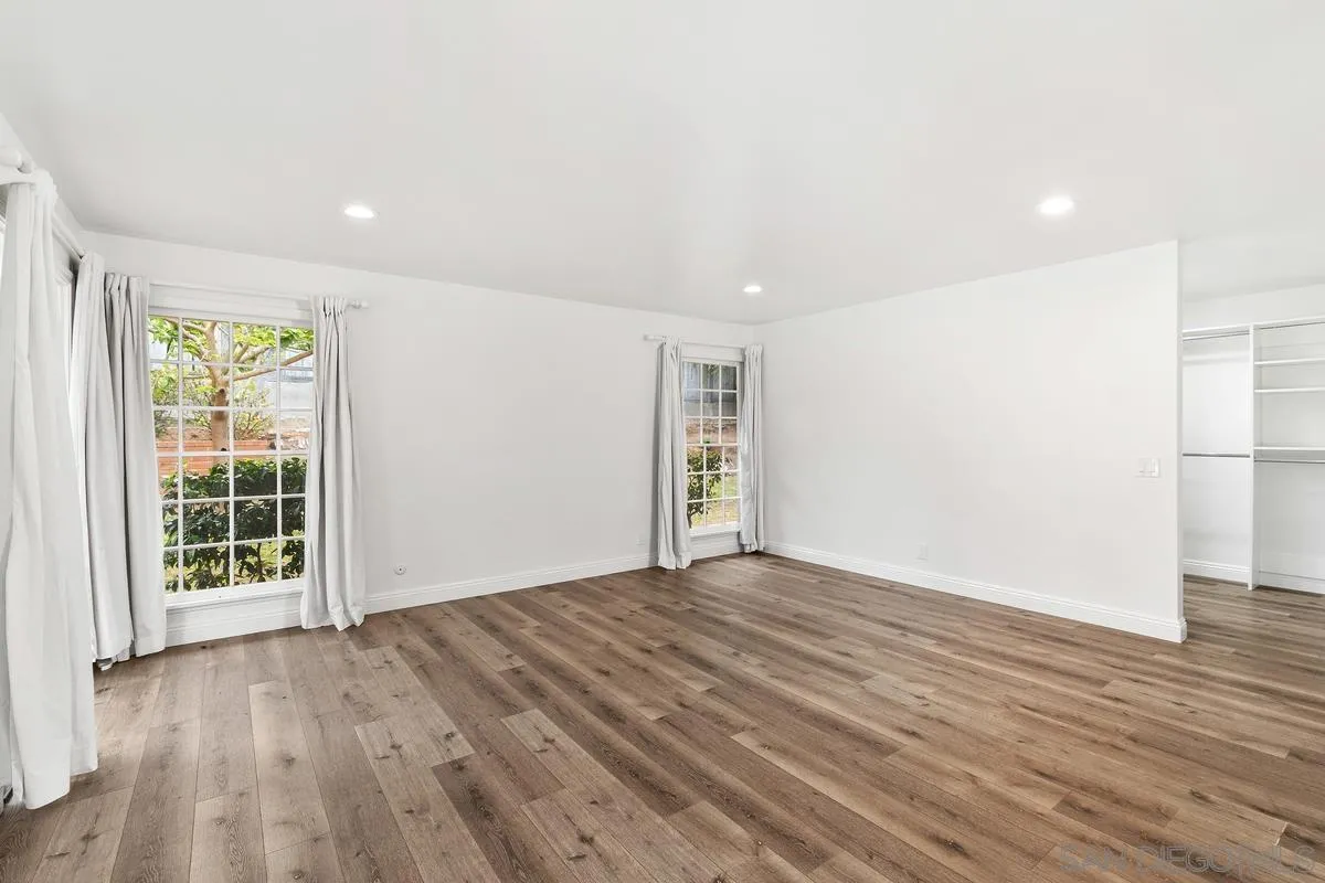 6229 La Jolla Mesa Drive La Jolla, CA 92037 - Photo 24 of 39 a view of an empty room with wooden floor and a window