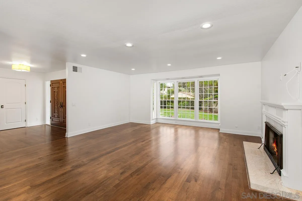 6229 La Jolla Mesa Drive La Jolla, CA 92037 - Photo 9 of 39 a view of an empty room with wooden floor and a window