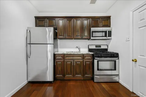 a kitchen with stainless steel appliances granite countertop a refrigerator stove and sink
