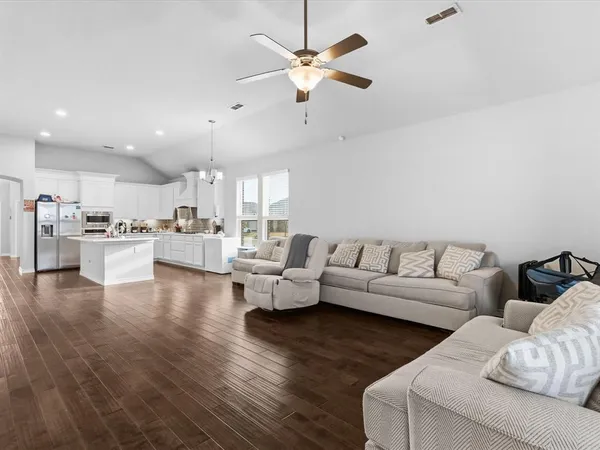 a living room with furniture and kitchen view