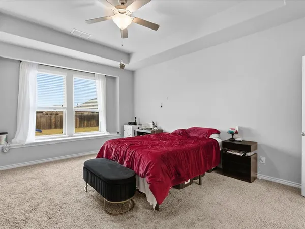 a bedroom with a bed and window