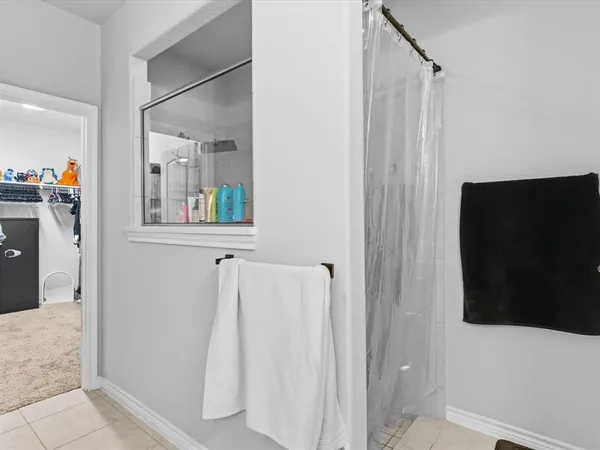 a bathroom with a shower and a sink