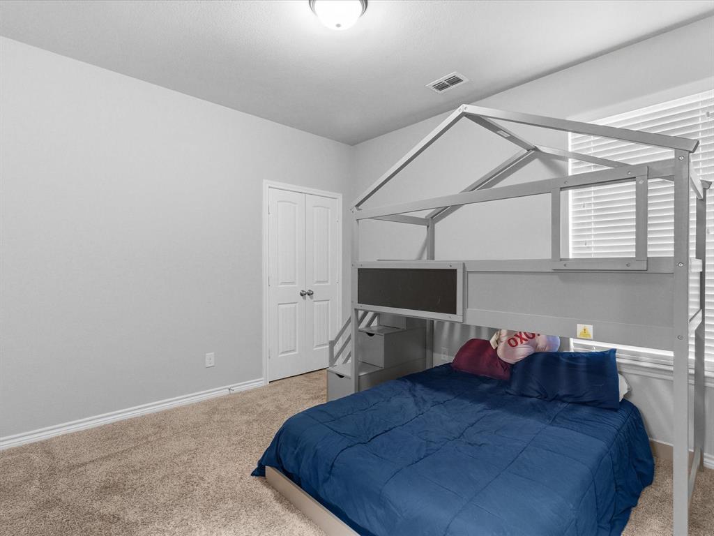 120 Garner Court Forney, TX 75126 - Photo 22 of 27 a bed room with a bed and a tv