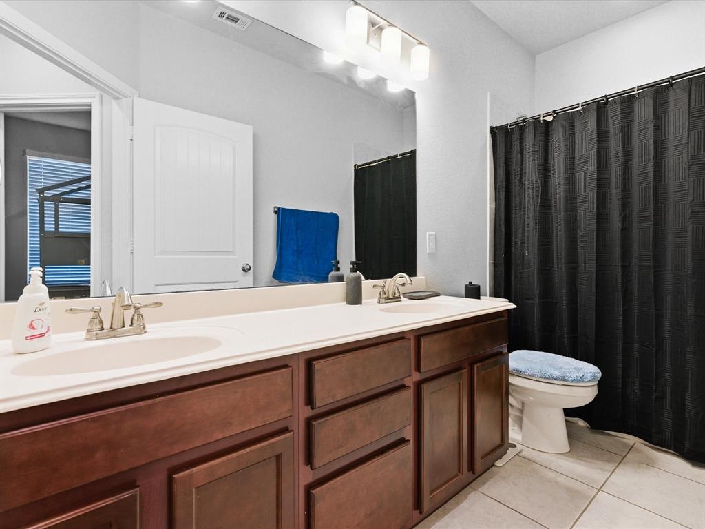 120 Garner Court Forney, TX 75126 - Photo 24 of 27 a bathroom with a double vanity sink and mirror