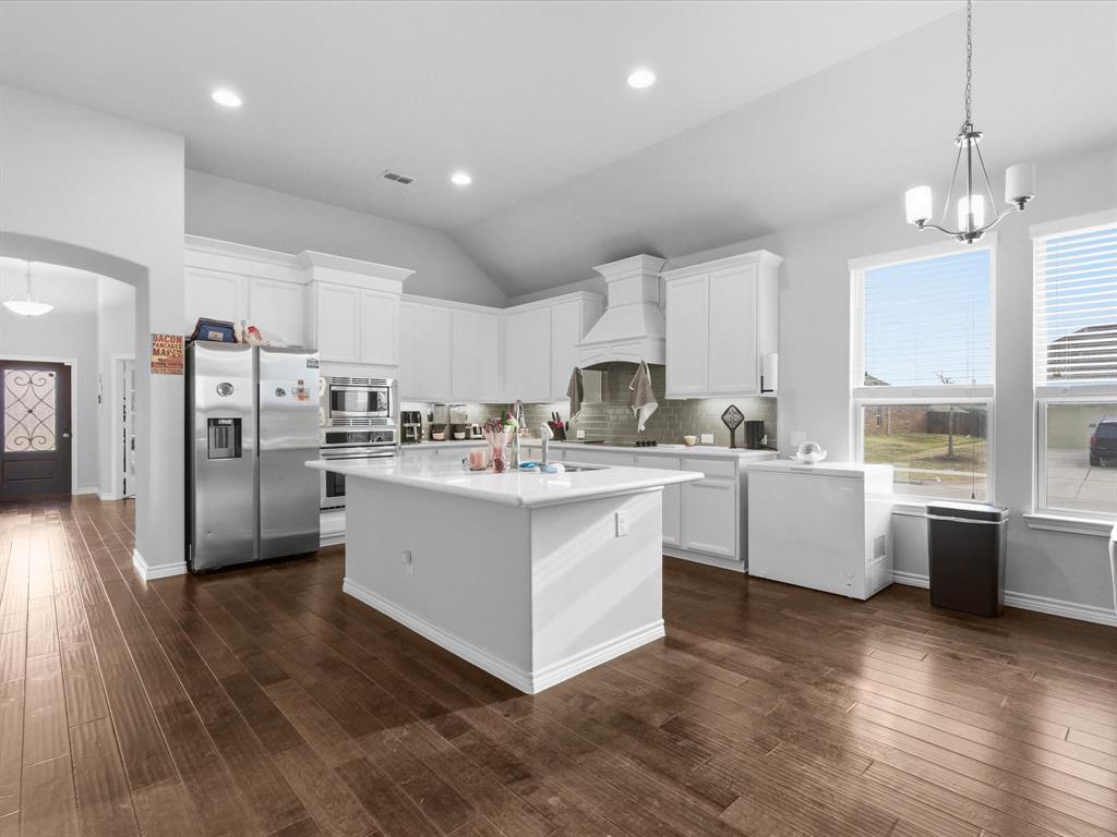 120 Garner Court Forney, TX 75126 - Photo 9 of 27 a kitchen with white cabinets and stainless steel appliances