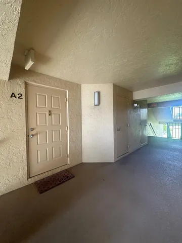 an empty room with a empty space and windows